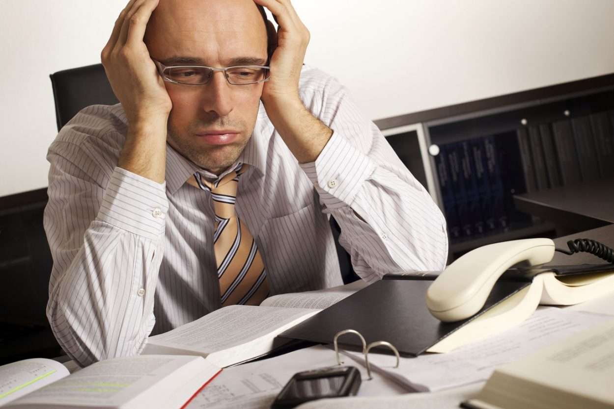 Self-Employment Taxes Are a Special Kind of Hell stressed man at desk
