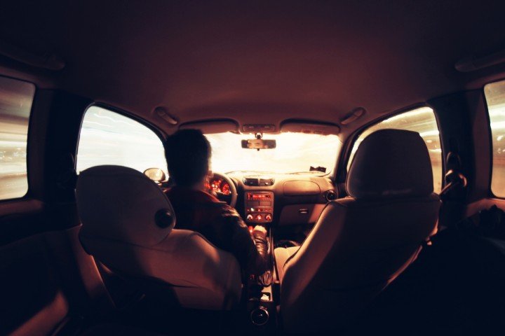 view of driver from rear seat