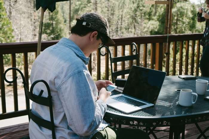 1 In 10 Workers Is An Independent Contractor, Labor Department Says Man with laptop coffee shop outside