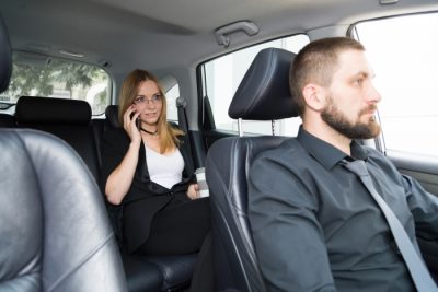 woman on phone in back of limo