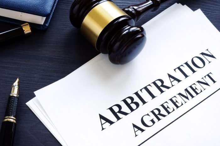 Arbitration agreement with gavel and blue background